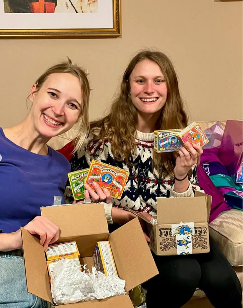 Customers unboxing Fishwife tins.